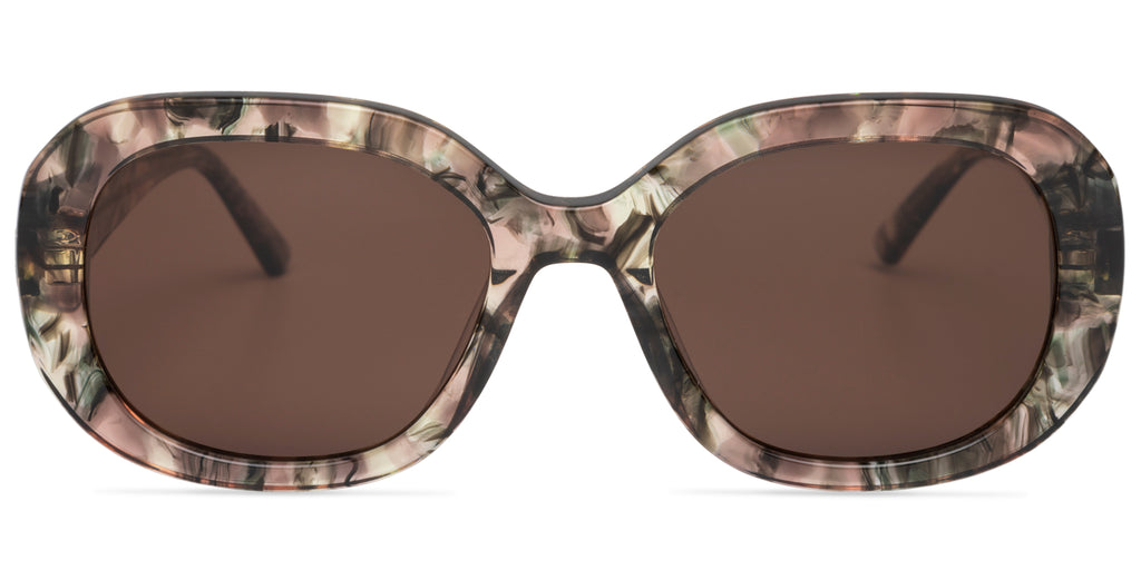 Sunglasses with a green and pink tort frame on a white background