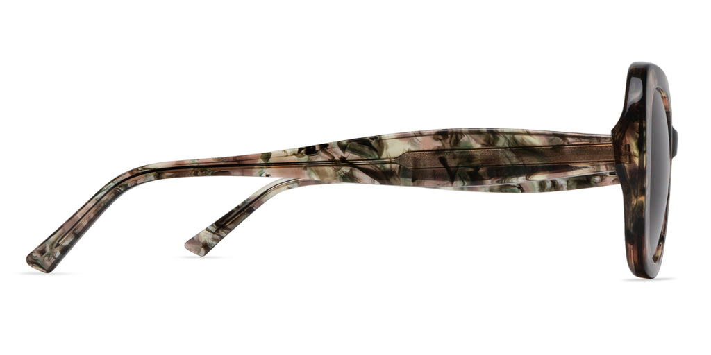 Sunglasses with green and pink tort frame on a white background side view