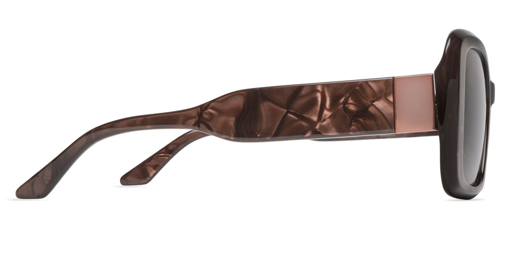Sunglasses with brown swirl frame and dark lenses on a white background with bronze gold embellishment side view