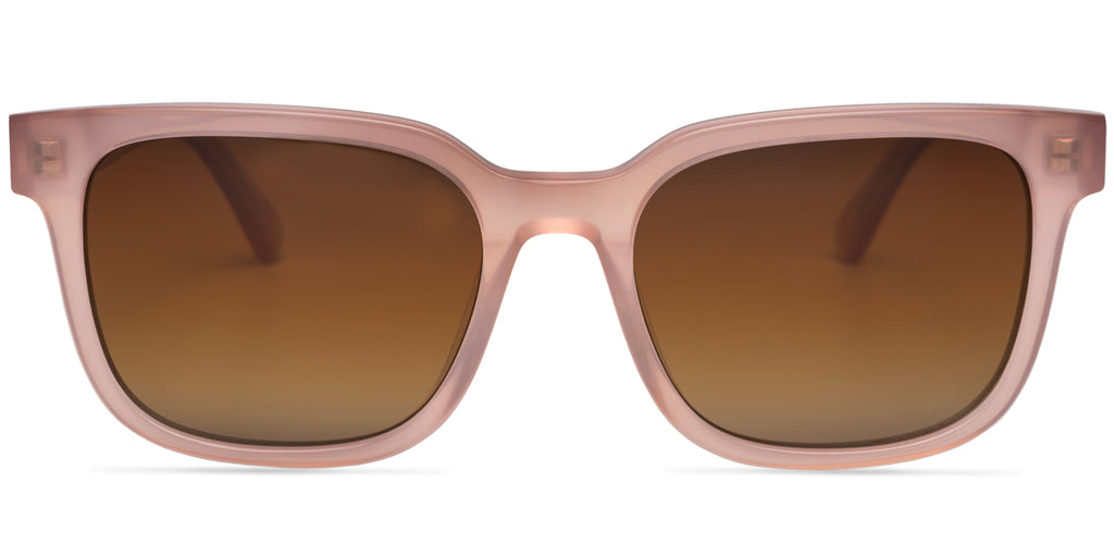 Sunglasses with a milky pink frame and brown lenses on a white background