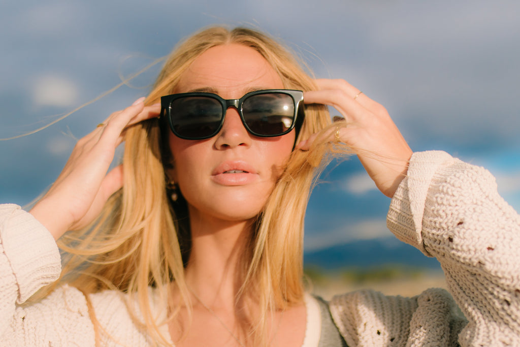 Woman wearing sunglasses with a blurred natural background